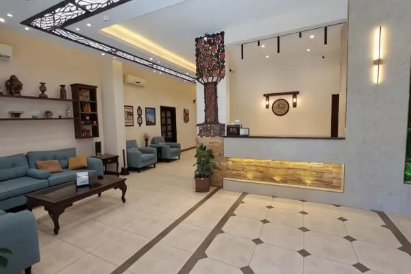 A welcoming view of the spacious lobby at Rumman Hotel, filled with natural light and comfortable seating